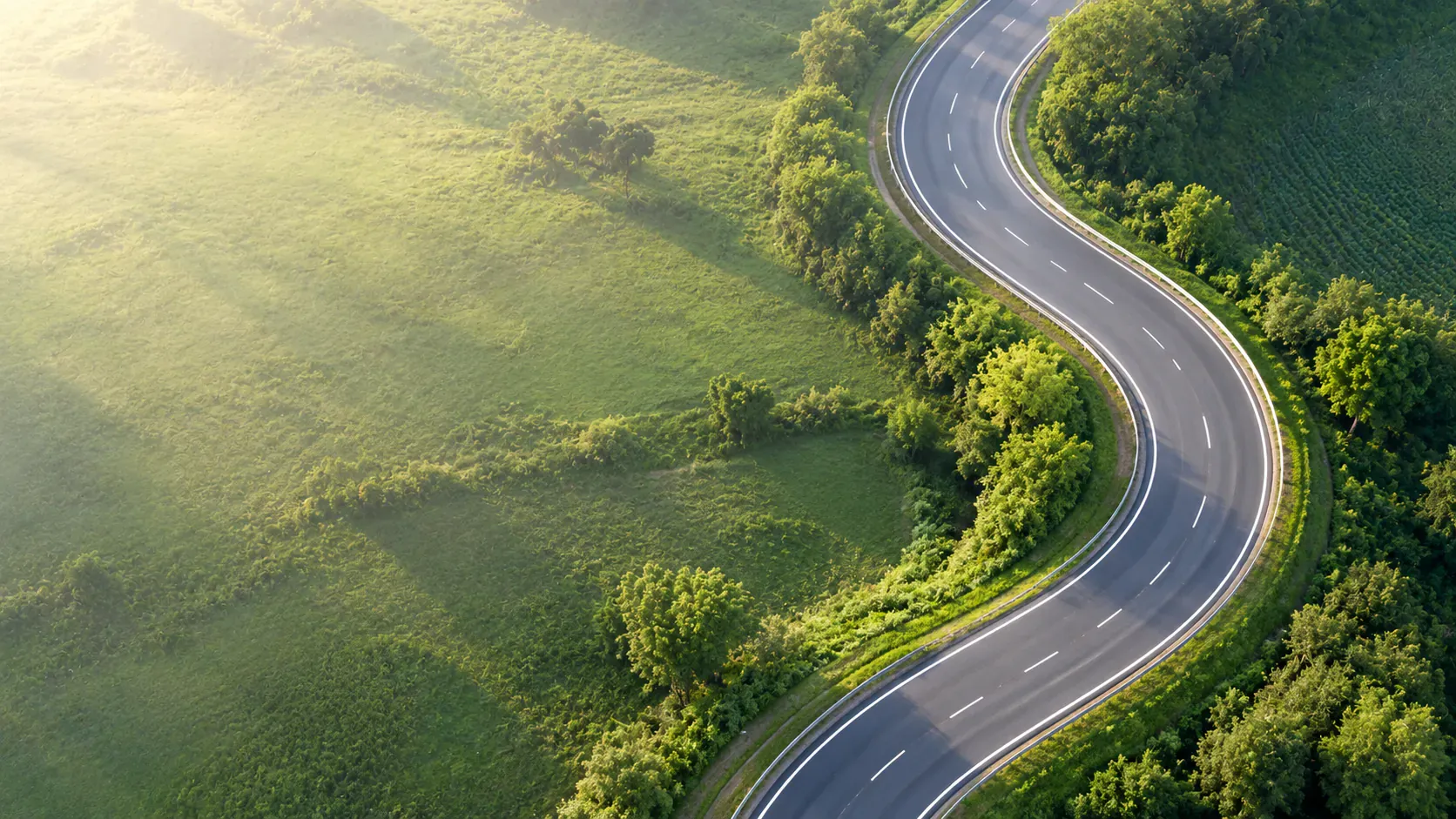 An empty curving road seen from above