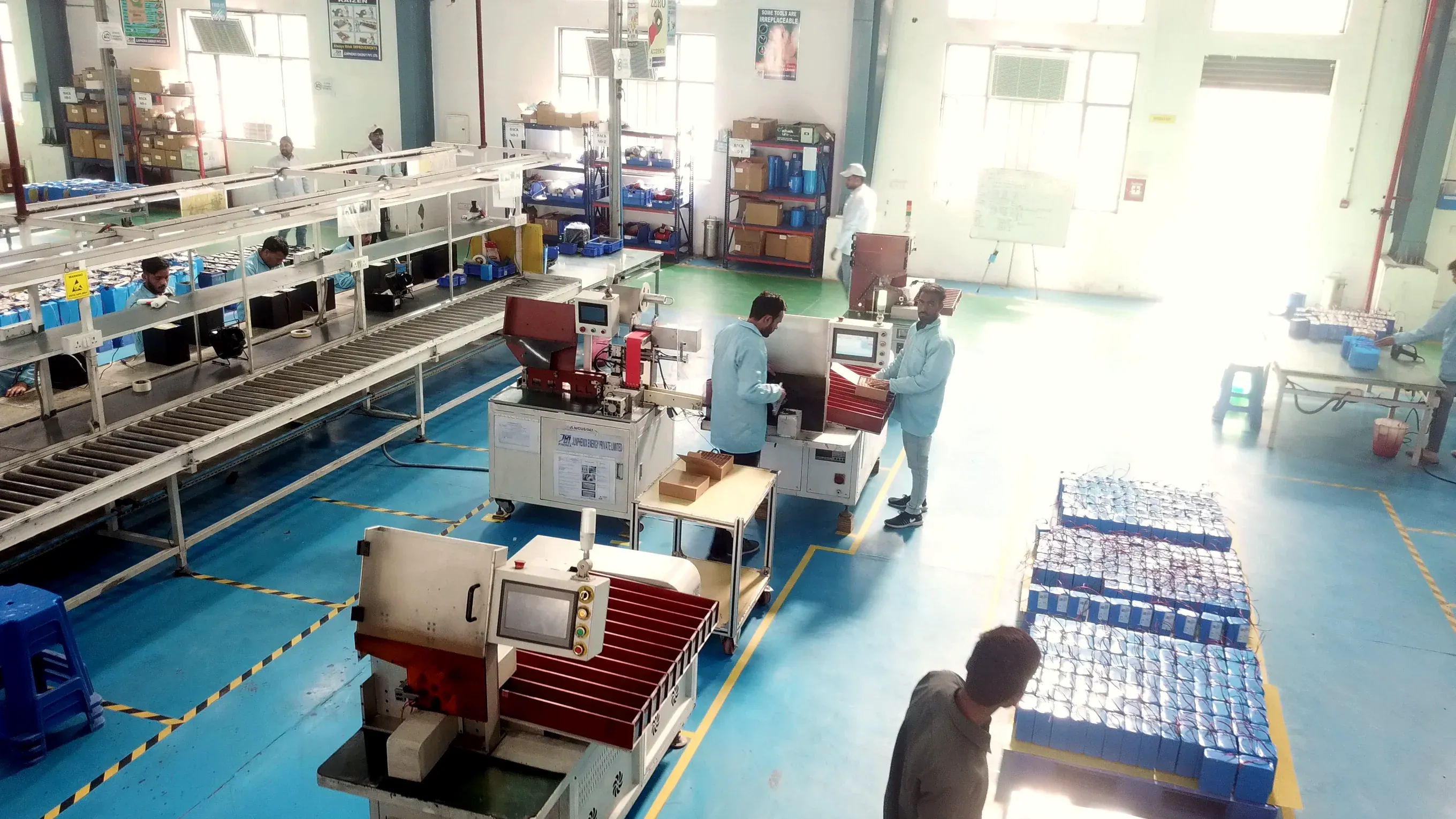 Trays of lithium cells beside the assembly machines