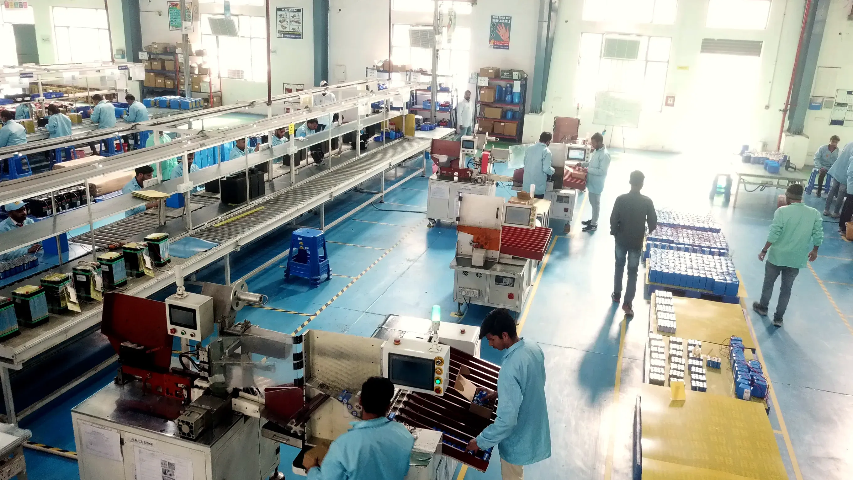 Technicians working on a battery assembly line